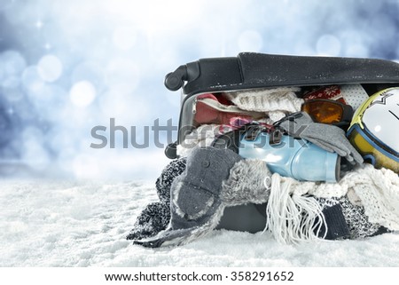 closeup of winter clothes in suitcase 