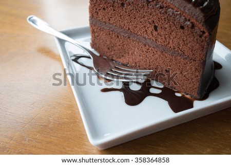 Piece of chocolate cake with warm chocolate syrup(soft focus)