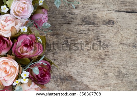 Vintage rose flowers on rustic wooden background. Copy space.
