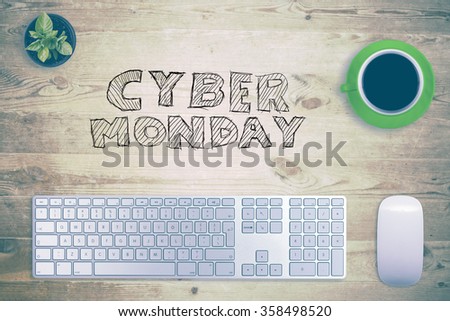 Cyber Monday message with workstation on wooden desk