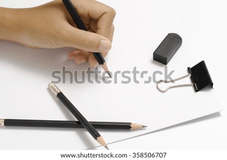 asia woman right hand writing with black pencil on paper over white background