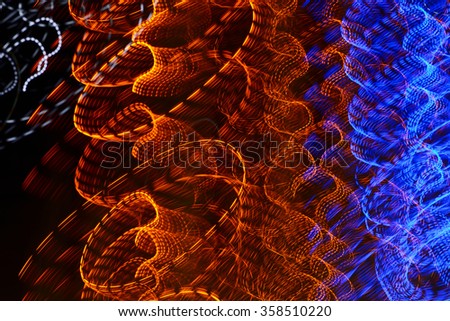 Abstract black background with bright multicolored luminous lines