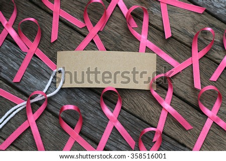 healthcare and medicine concept. pink breast cancer awareness ribbon on wood table.