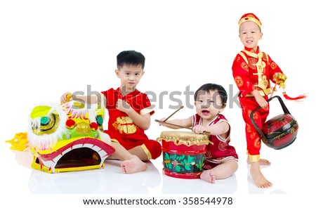 Asian Chinese kids in traditional Chinese costume, cheongsam celebrating chinese new year , isolated on white background.