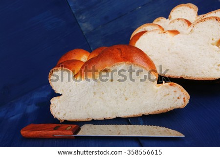sweet bread : golden challah cuts over blue wooden plate