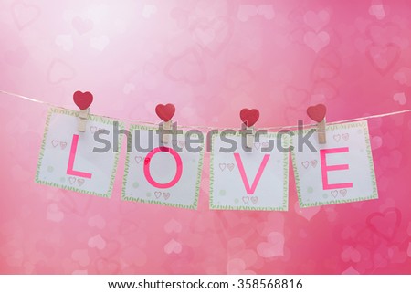 love symbol and hearts hanging on the clothesline with blank note for text