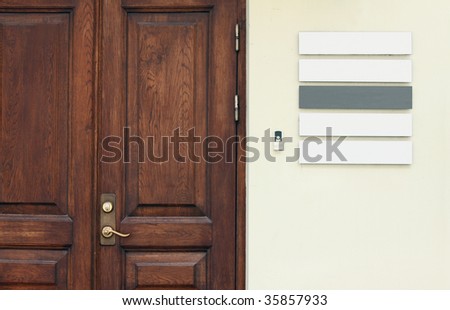 Classic real office door with empty signboards to place company names and logos