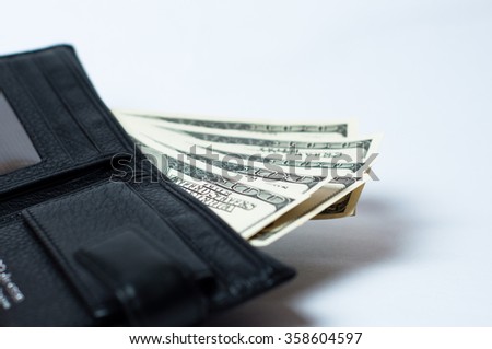 Dollars in purse on a white background