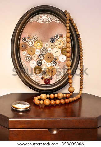 Heart of brown buttons in a vintage frame
