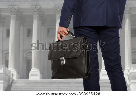 The lawyer with a briefcase is on against the courthouse