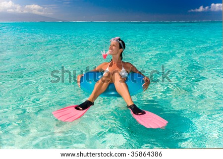 beautiful woman having fun floating in turquoise waters