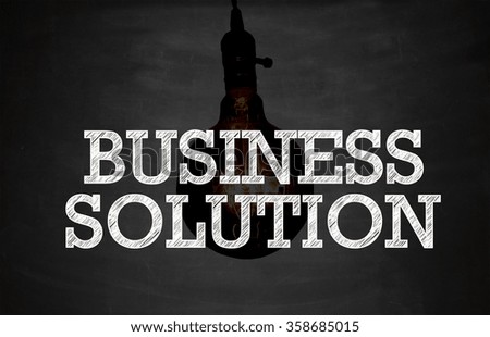 dark bulbs with BUSINESS SOLUTION on Blackboard , business concept , business idea