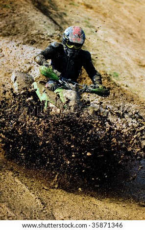 Man riding ATV in muddy conditions