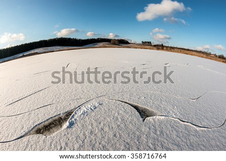 Traces of ice-skates on pure snow-covered surface of the lake