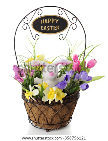An adorable toy rabbit surrounded by colorful spring flowers, all in a wire basket with a welcome sign on the handle overhead.