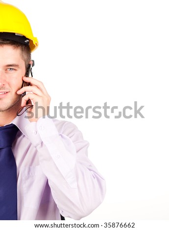 Young construction worker smiling isolated on white with copyspace