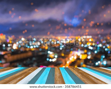 wood table and blur lights from Chiang Mai, Thailand in night time for background usage .