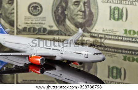 Concept :rise of freight and passenger traffic in the world. Figure the plane on the background of hundred-dollar bills.