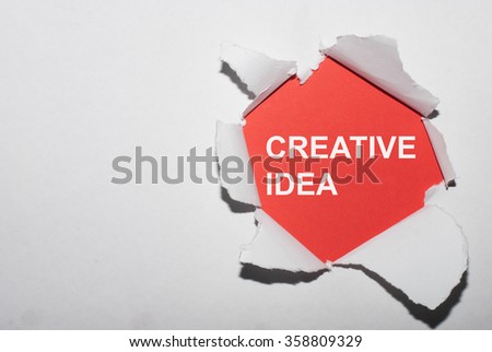 creative idea written behind a torn paper