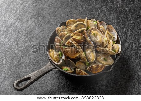iron pan and short-necked clam butter Royalty-Free Stock Photo #358822823