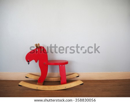 Baby rocking horse on wooden floor.
