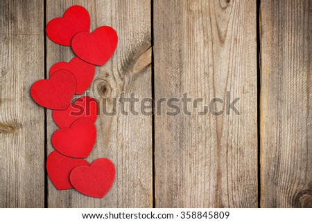 Still life, love and holidays concept. Red heart hanging on the clothesline for Valentines Day. Selective 
focus, top view, copy space rustic wooden background
