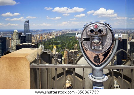 Zoom binoculars on Rockefeller Center with view on a Manhattan Central Park in NYC Royalty-Free Stock Photo #358867739