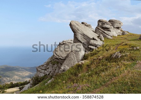 Rocks in the form of giant lizards on background of blue sky. Three lizard natural wonder of nature.