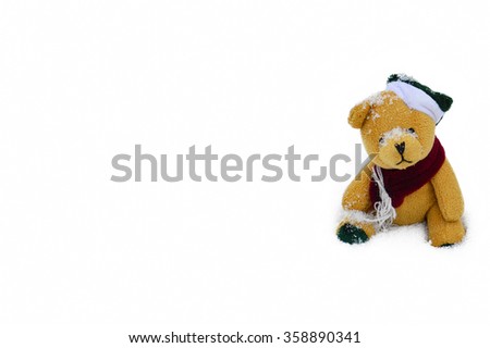 Cute teddy bear sits in the snow - isolated in white background for christmas or new year 2016