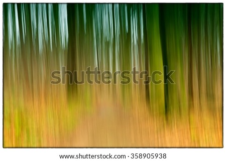 A slow shutter speed coloured photo of trees in a forest showing green, orange leaves and lavender colours with a strong bi-colour filter in Europe