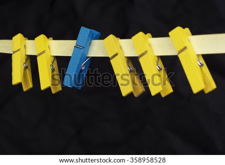 colorful wooden clothespin - selective focus, standing out from the crowd, leadership, be difference concept. toned image
