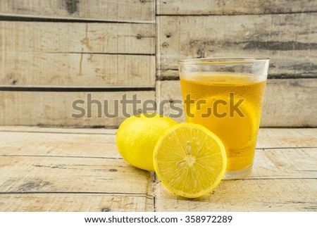 Ice lemon tea on wooden background.