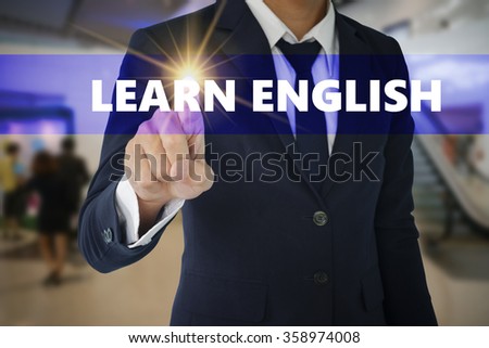 Businessman hand touching LEARN ENGLISH tab on virtual screen , business concept , business idea