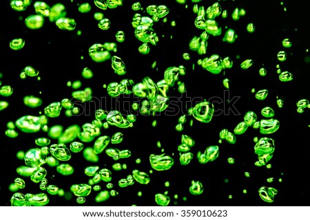 Air bubbles green on a black background.