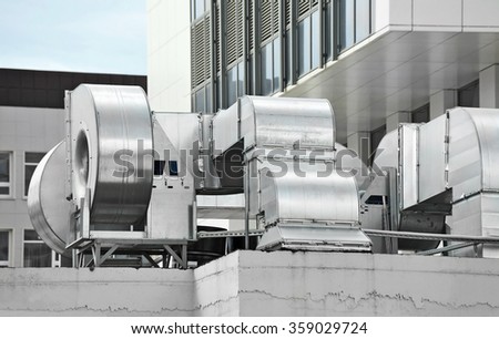 Industrial air conditioning and ventilation systems on a roof Royalty-Free Stock Photo #359029724