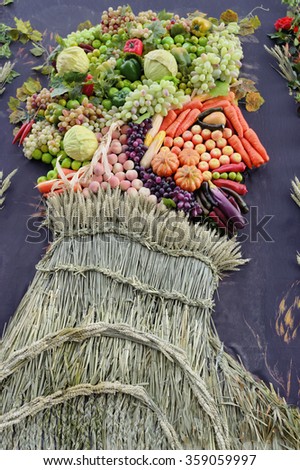 painting a portrait in profile man of the autumn harvest of fruits and vegetables laid out on the canvas