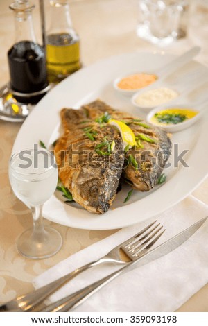 Healthy food. Fish on the plate with lemon and sauce