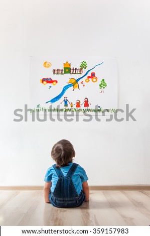 child looking at the picture on the wall