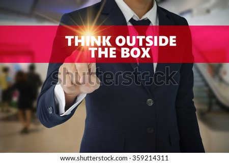 Businessman hand touching THINK OUTSIDE THE BOX tab on virtual screen , business concept , business idea