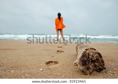 A young girl looking to the sea.