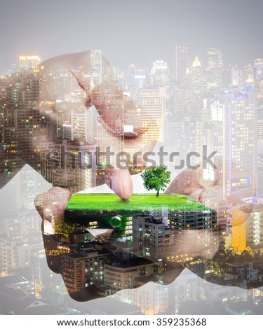 Concept of smart phone share green nature to urban life. Double layers view of city scape and indoor hand image.