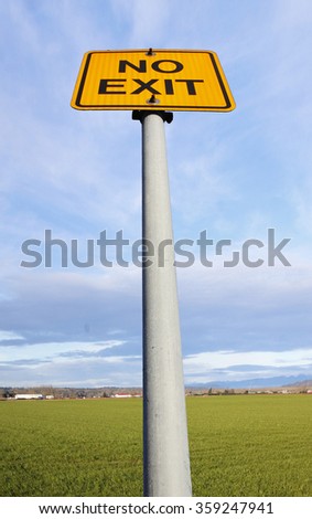 a low angle view of no exit sign on pole