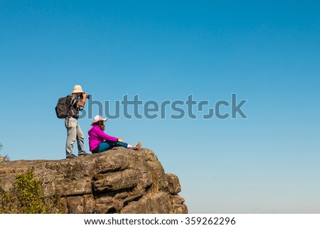 Men photographer taking photos in the mountains.