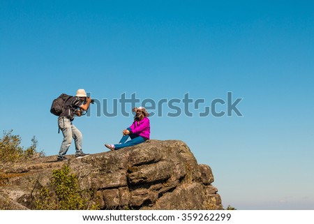 Women photographer taking photos in the mountains.