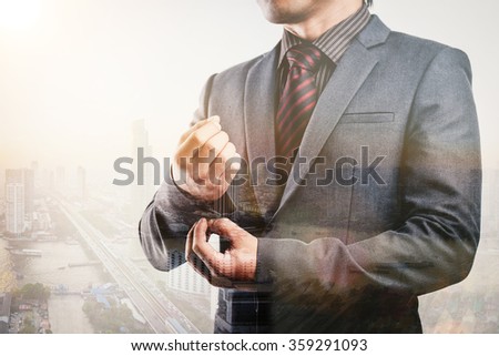 Businessman on blurred city background
