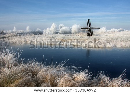A watermill in a Frisian winter landscape Royalty-Free Stock Photo #359304992