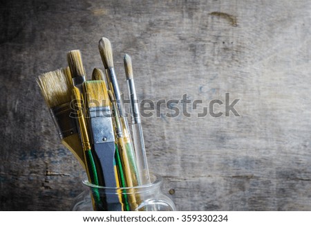 Paintbrushes in a glass jar