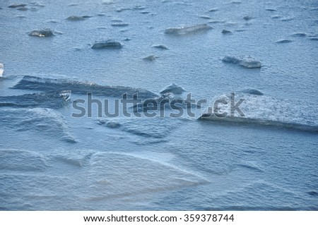 Winter background. Closeup of cracked ice texture. Cracked ice on winter river. Breaking Up. Broken ice. 