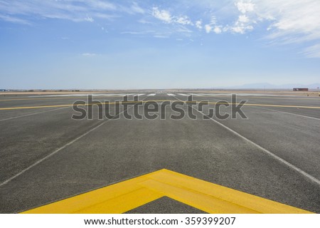  landing light Directional sign markings on the tarmac of runway at a commercial airport Royalty-Free Stock Photo #359399207