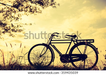 beautiful landscape image with vintage Bicycle at sunset,classic bicycle,old bicycle style for greeting Cards ,post card